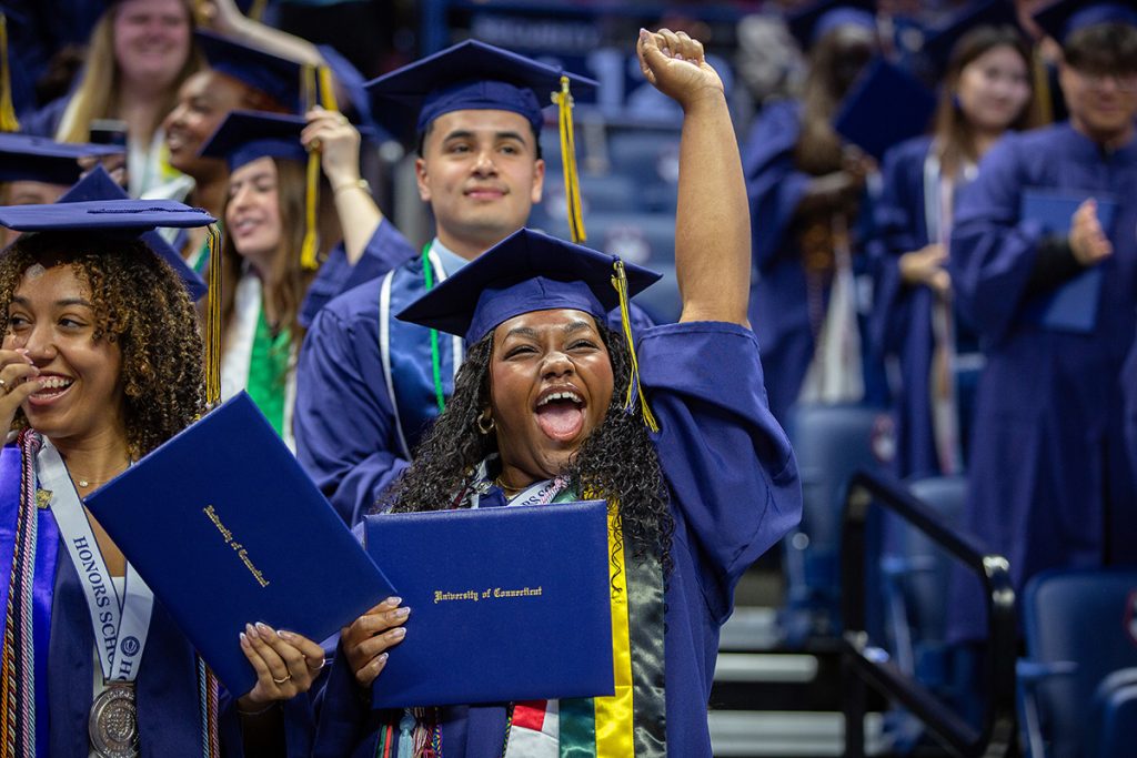 A graduate celebrates after receiving her diploma.