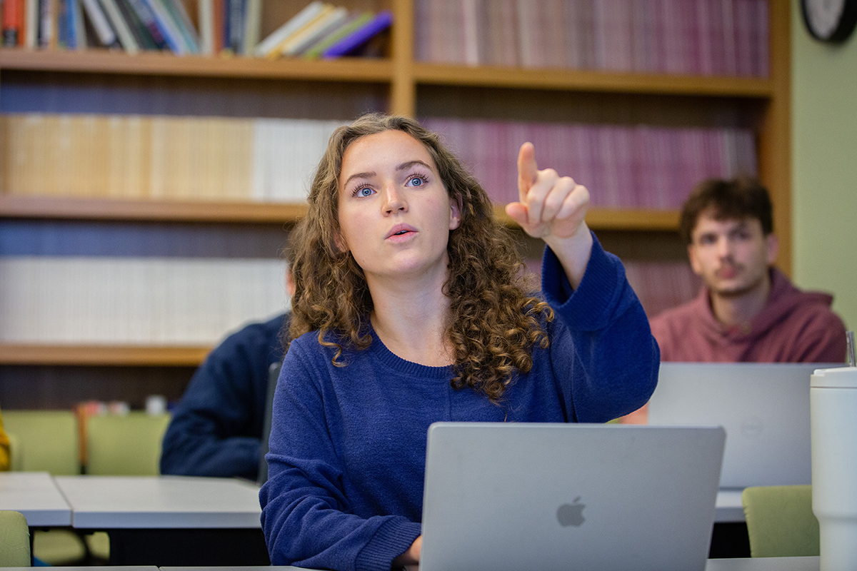 A student points during a class.